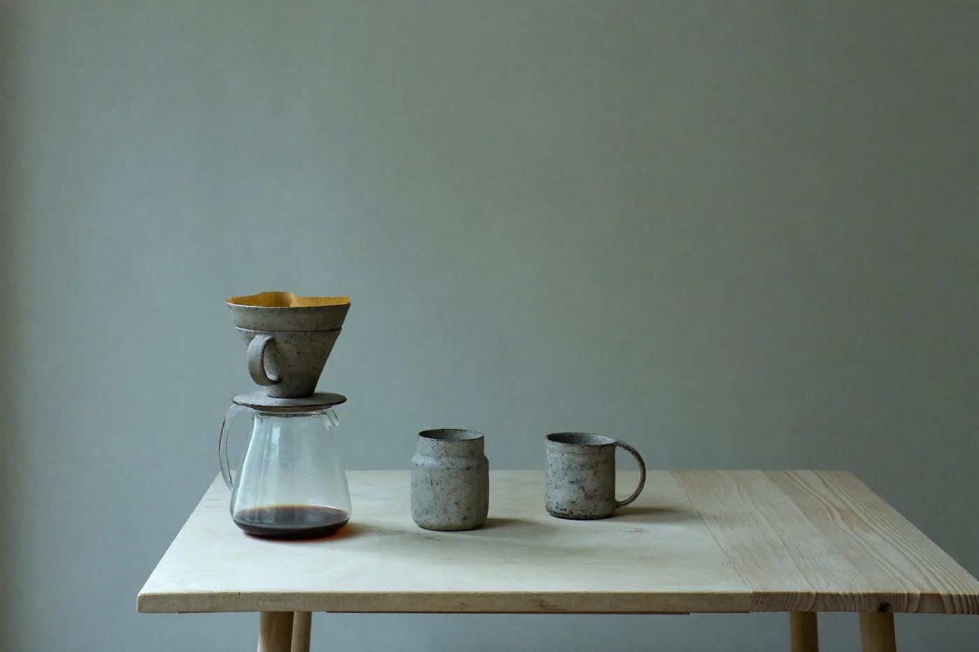 Stoneware pour-over set mid-brew with thin steam rising