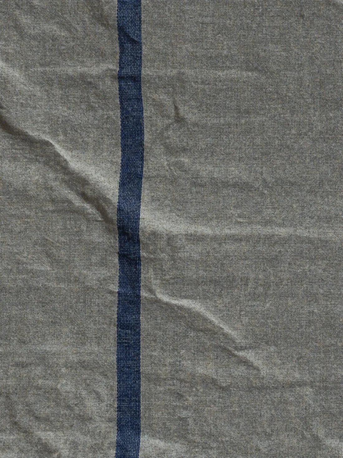 Close crop of hand-loomed cotton-linen cloth with a cobalt stripe