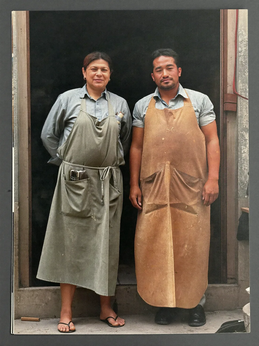 Two makers standing at the open door of their workshop